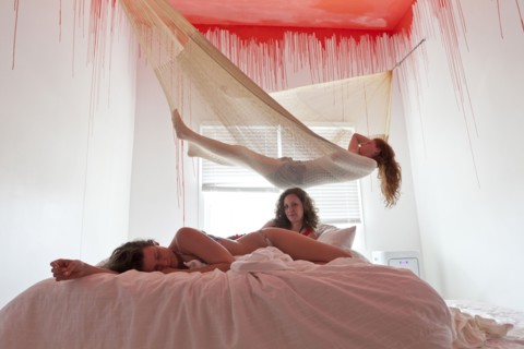 Women laying on bed and hammock under dripping ceiling