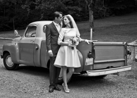 Bride and groom smiling near vintage truck