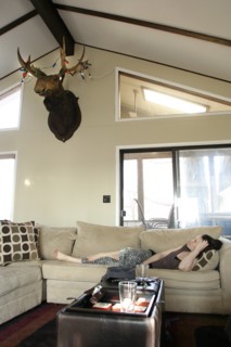 Woman laying on sofa in living room