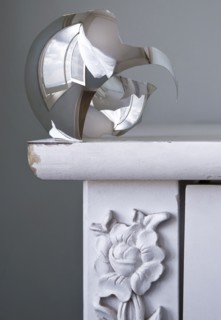 Close up of shattered metal bulb on table