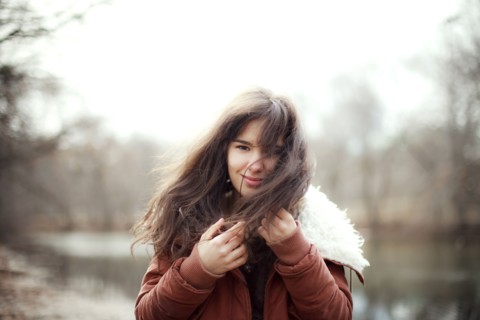 Caucasian woman wearing furry coat outdoors