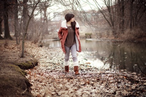 Caucasian woman walking near rural creek