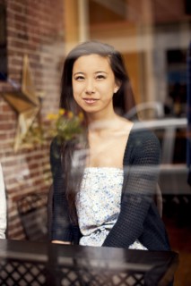 Woman smiling behind window in cafe