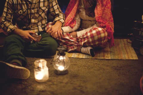 Couple relaxing in camping tent at night