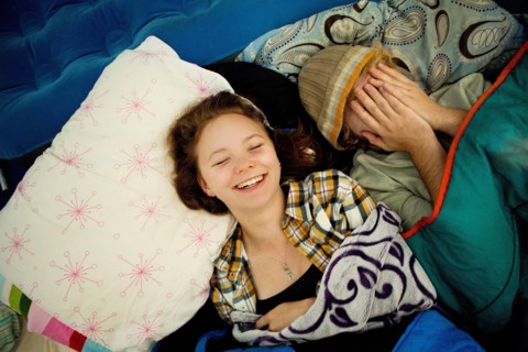 Couple laughing in camping tent