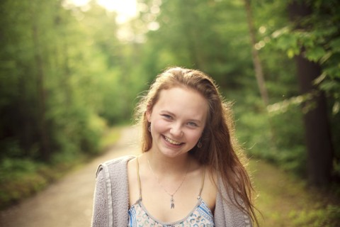 Caucasian girl smiling on forest path
