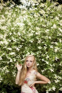 Woman standing under flowering tree