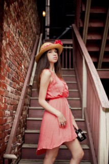 Girl wearing straw hat on staircase