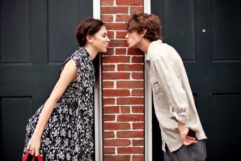 Couple puckering in doorways