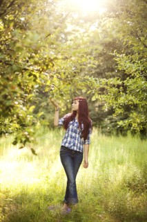 Girl admiring trees in rural field