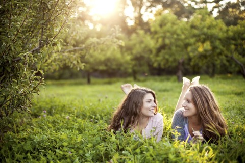 Caucasian women laying in rural field