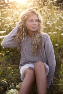 Woman sitting in tall flowers