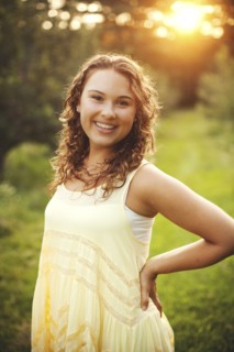 Smiling woman standing in rural field