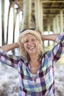 Caucasian woman standing under boardwalk on beach