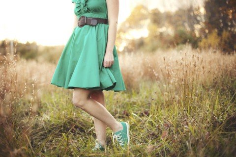 Woman standing in tall grass in rural field