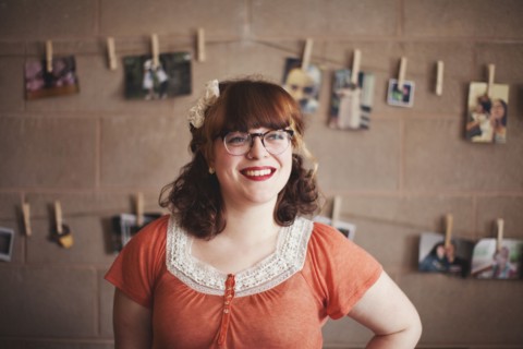 Caucasian photographer standing near hanging photographs