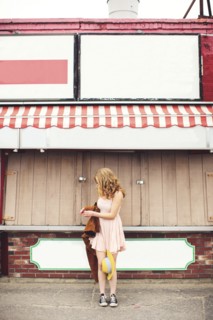 Caucasian teenage girl standing outside pizzeria