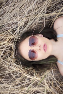 Caucasian woman laying in hay