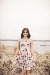 Caucasian woman standing in beach grass