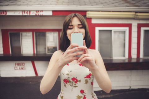 Caucasian woman taking selfie with cell phone