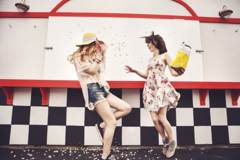 Caucasian friends having popcorn fight outdoors