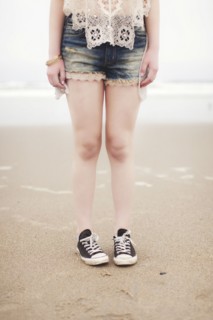 Caucasian teenage girl standing on beach