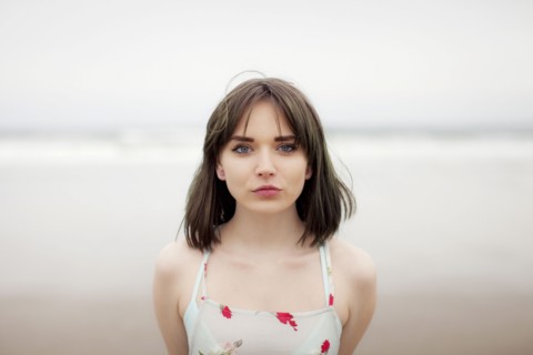 Caucasian woman standing on beach