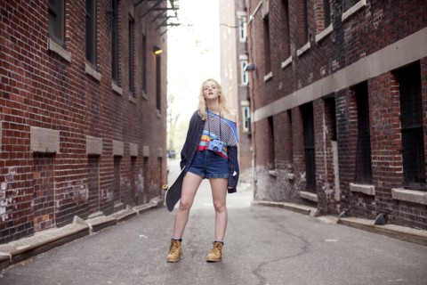 Caucasian woman standing in city alleyway