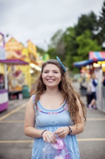 Caucasian woman eating candy at amusement park