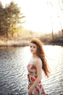 Hispanic woman standing in rural lake