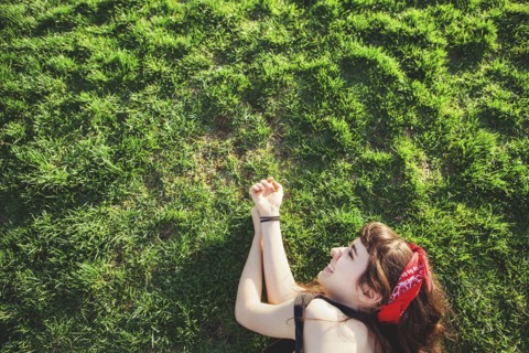 Caucasian woman laying in grass