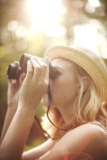 Caucasian woman looking through binoculars