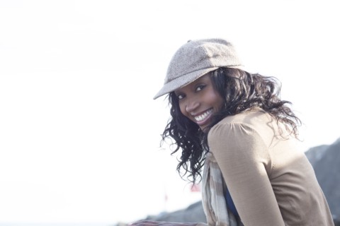 Close up of smiling woman wearing cap outdoors
