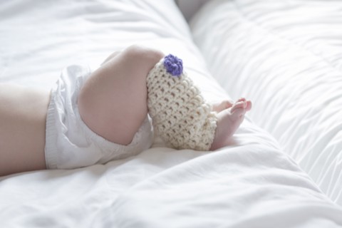 Close up of baby girl wearing leg warmer