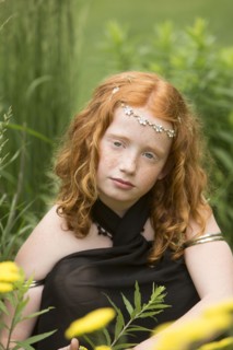 Caucasian girl wearing flower crown in garden