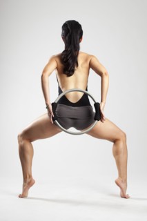 Caucasian woman exercising with resistance ring