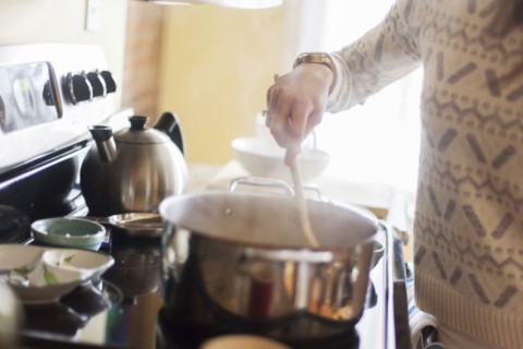 Close up of woman cooking in kitchen