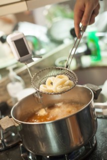 Close up of woman frying onions in kitchen