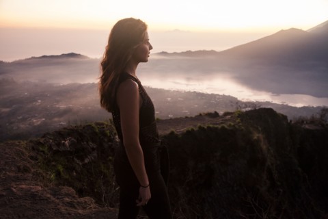 Woman admiring rural landscape from mountaintop