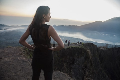 Woman admiring rural landscape from mountaintop
