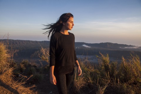 Woman admiring rural landscape from mountain path