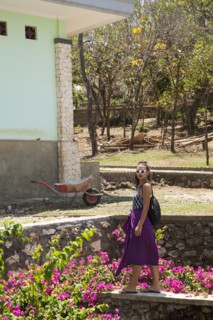 Woman walking by rock wall in garden