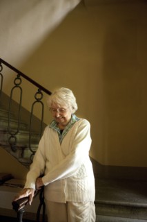 Older Caucasian woman climbing stairs