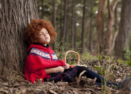 Girl napping under tree in park