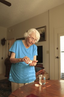 Older Caucasian woman taking medication
