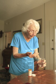 Older Caucasian woman taking medication