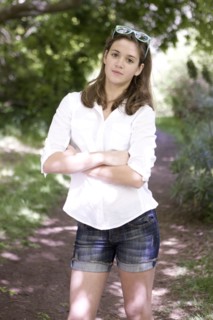 Caucasian teenage girl standing on dirt path