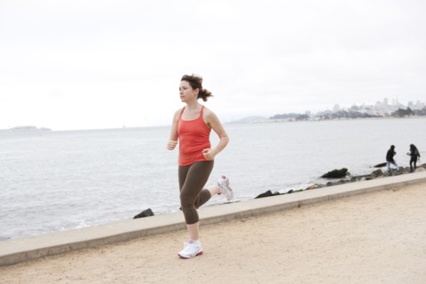 Caucasian woman running on waterfront