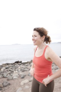 Caucasian woman standing on rocky beach