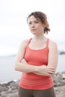 Caucasian woman standing on rocky beach
